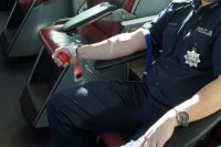 policjant oddaje krew, siedzi na fotelu