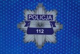 gwiazda policyjna  na niebieskim tle z napisem policja i 112