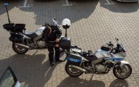 Policjanci przygotowują się do służby na motocyklach.
